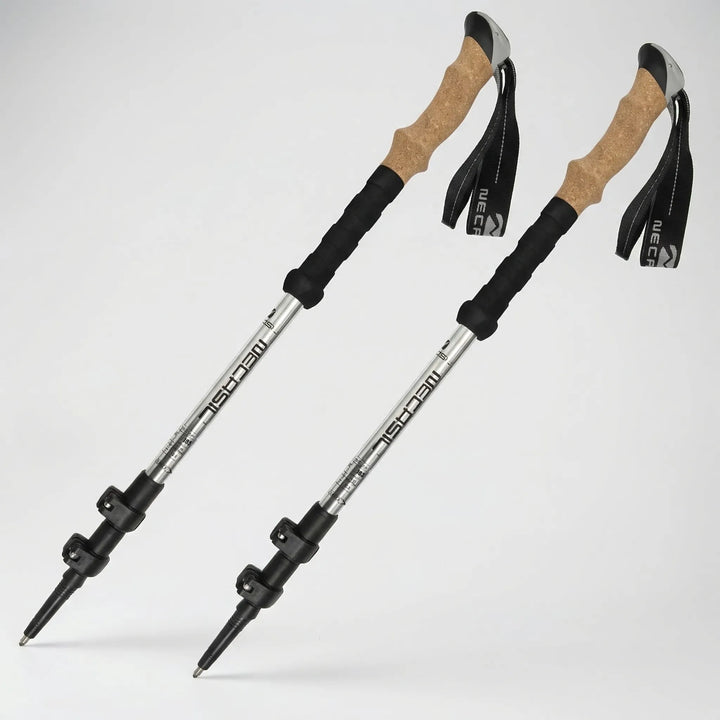 Adjustable hiking poles featuring ergonomic cork grips and rugged tungsten carbide tips for varied terrain.