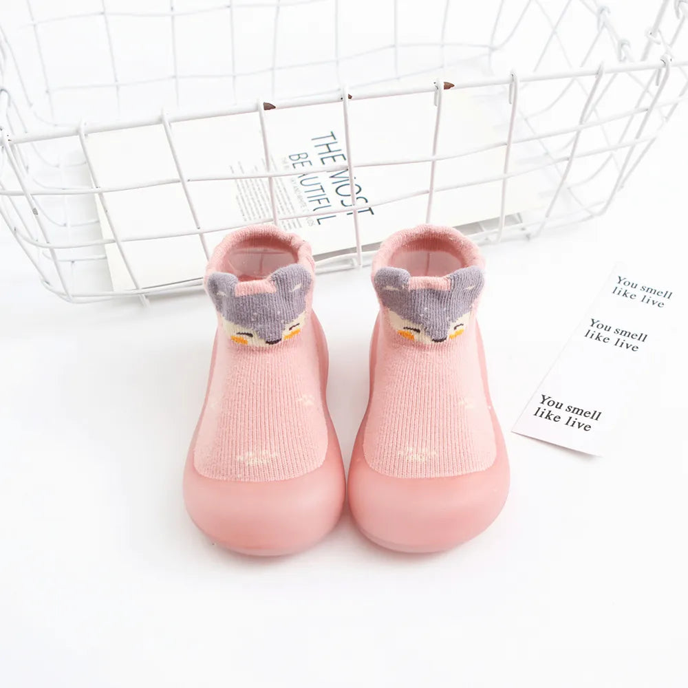 Orange anti-slip baby socks, breathable cotton and flexible rubber sole, ideal for crawling.