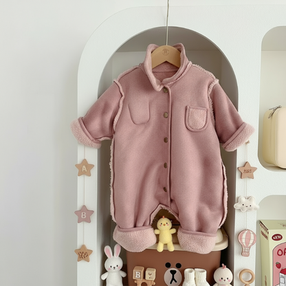 Detail of hooded baby winter romper fabric, showing thick, fleece lined material, unisex comfort