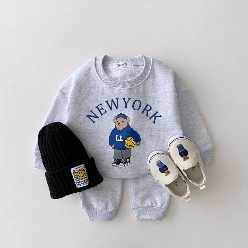 Ready-to-wear unisex baby clothes: bear print hoodie and solid color pants for daily comfort.