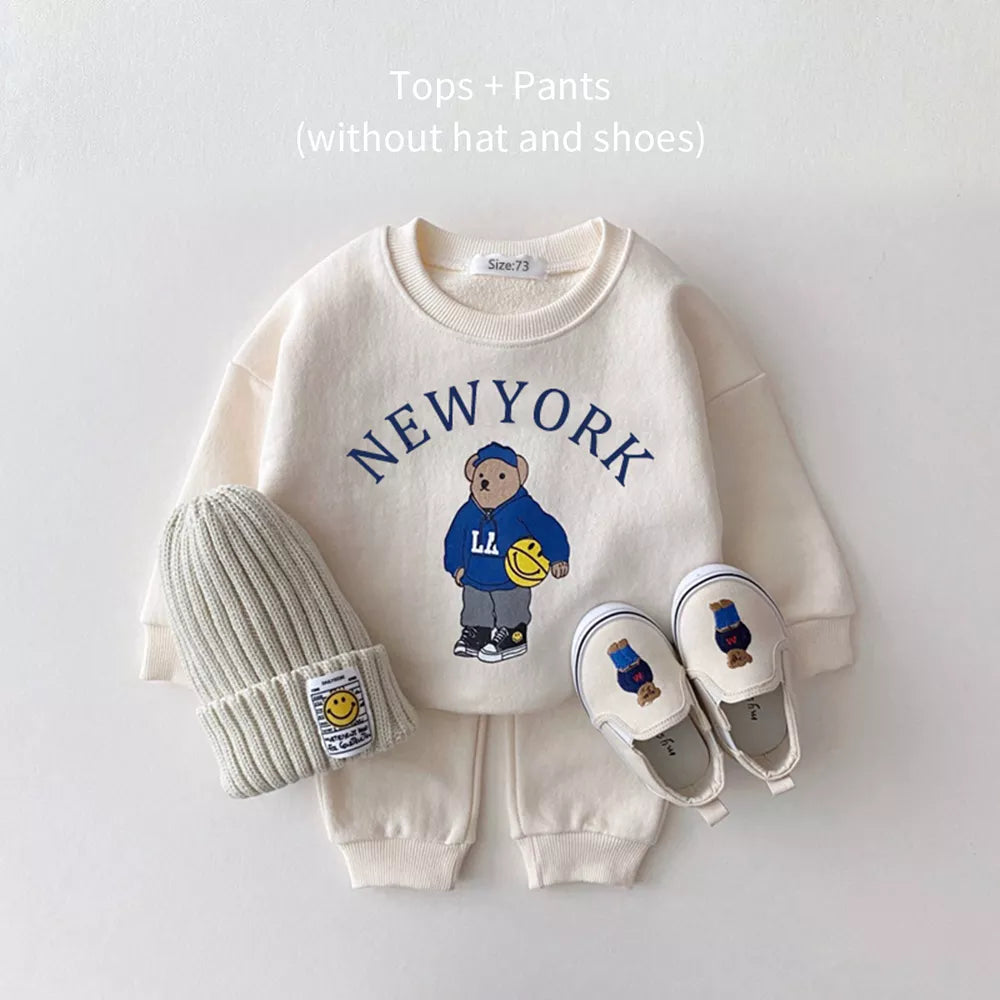 Two-piece unisex baby outfit featuring a bear-themed hoodie and coordinating solid pants.