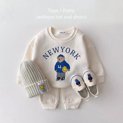 Two-piece unisex baby outfit featuring a bear-themed hoodie and coordinating solid pants.