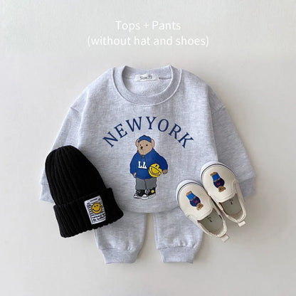 Stylish kids fashion: cotton unisex baby hoodie and pant set with playful bear imagery.