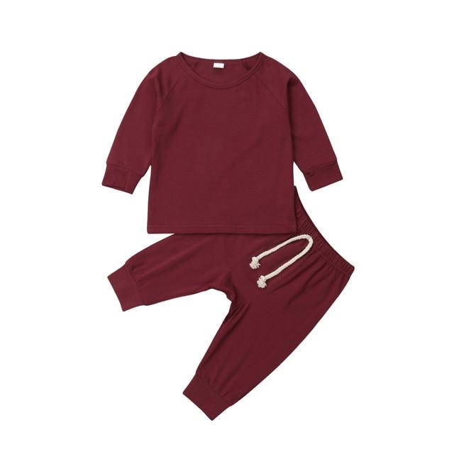 Close-up of snap buttons and ribbed neckline on a unisex baby cotton sleepsuit