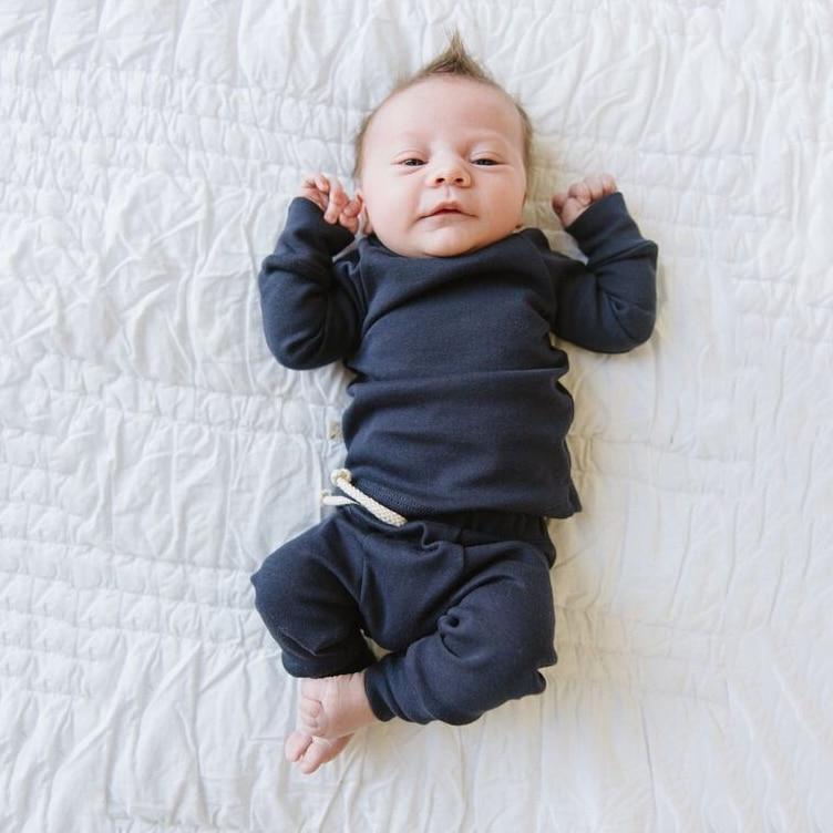 Newborn essentials: white ribbed cotton sleeping suit with easy-access snaps