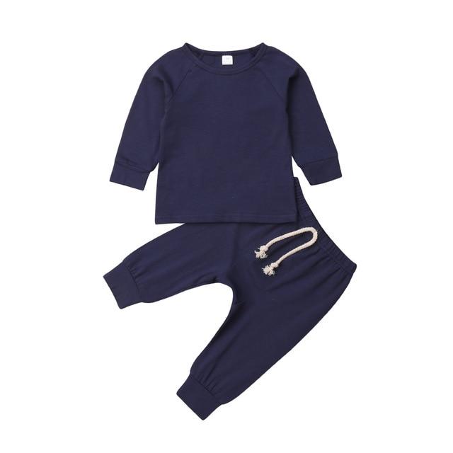 Unisex baby sleepsuit set in a stack with different neutral colors, soft cotton