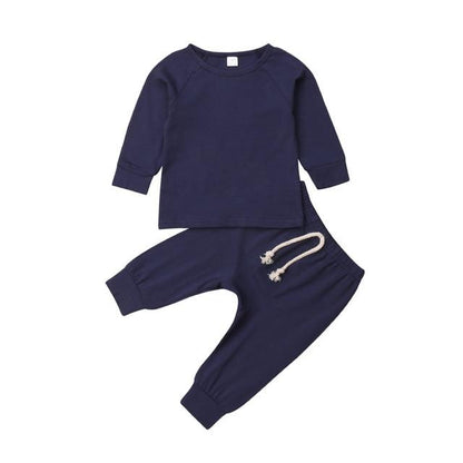 Unisex baby sleepsuit set in a stack with different neutral colors, soft cotton