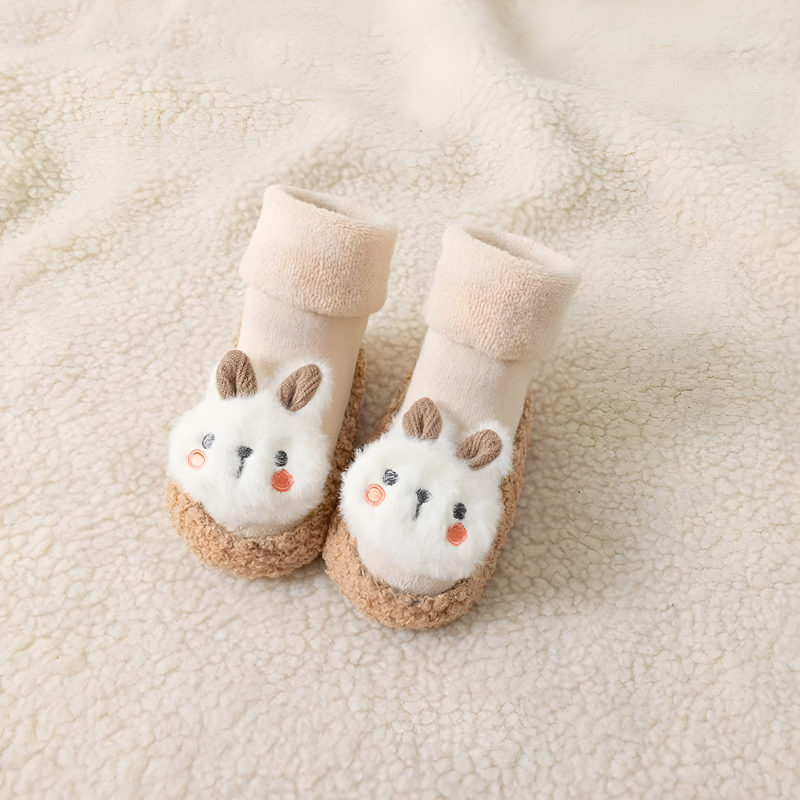 Close-up of a baby bunny sock shoe showing the soft, flexible sole and non-slip traction for early walking.
