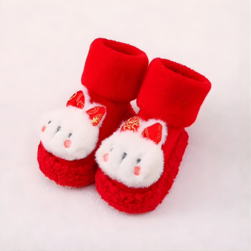 Non-slip infant footwear: bunny design sock shoes for babies learning to walk, with a flexible, soft sole.