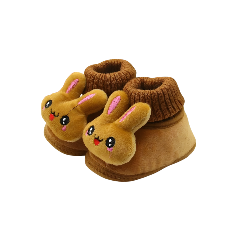 Pair of unisex baby bunny winter booties in a cozy crib setting, ideal for infant warmth