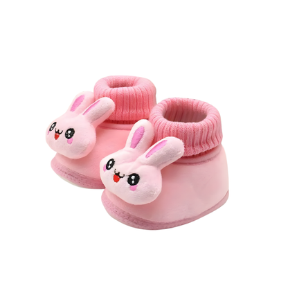 Infant feet wearing soft sole unisex baby bunny winter booties, showing comfortable fit