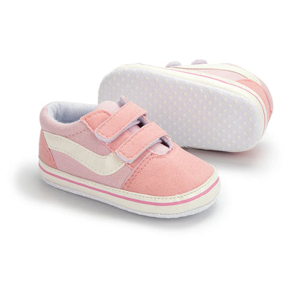 Soft sole infant canvas shoes, unisex design, promoting natural foot development.