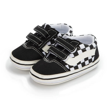 Easy-to-wear unisex infant canvas shoes with hook and loop fasteners and soft sole.