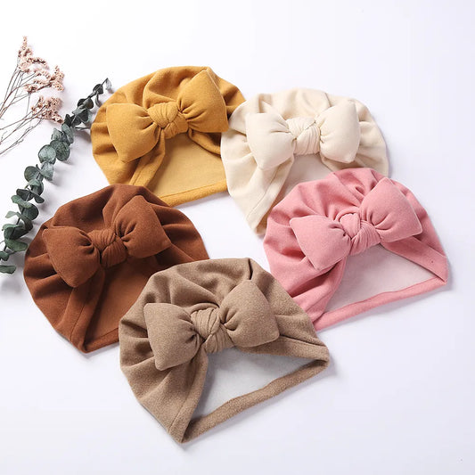 Unisex Baby Cashmere Bow Topknot Bonnet, soft cashmere-like infant hat with bow detail