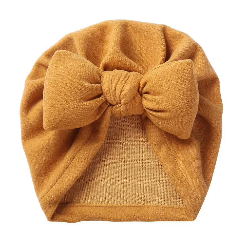 Cashmere-like baby hat with a charming bow tie, comfortable and stylish for newborns