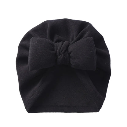 Folded cashmere-like bow topknot bonnet, showcasing its soft texture and quality