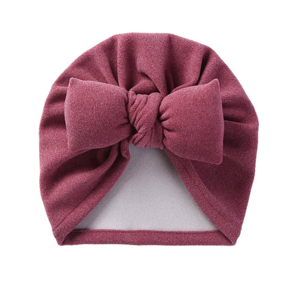 Topknot baby hat with a cute bow detail, made from premium cashmere-like material