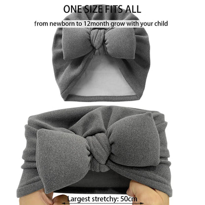 Baby wearing a warm unisex cashmere-like topknot bonnet with a cute bow accent