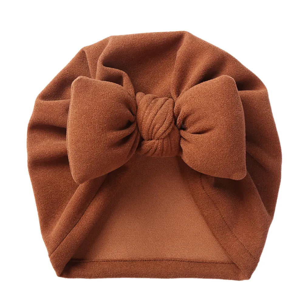 Soft infant bow bonnet in a cashmere blend, perfect newborn accessory and baby gift