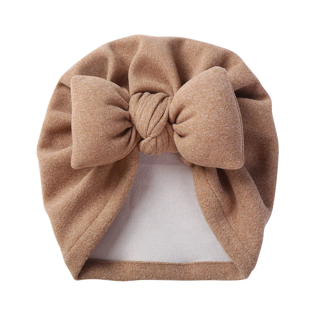 Newborn cashmere-like bonnet with a stylish bow detail, soft and gentle on baby's head