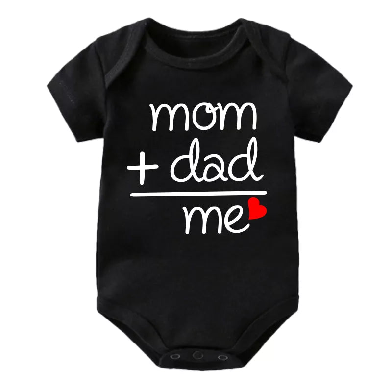 Baby boy in a green cotton jumpsuit set, showcasing the unisex design and soft material