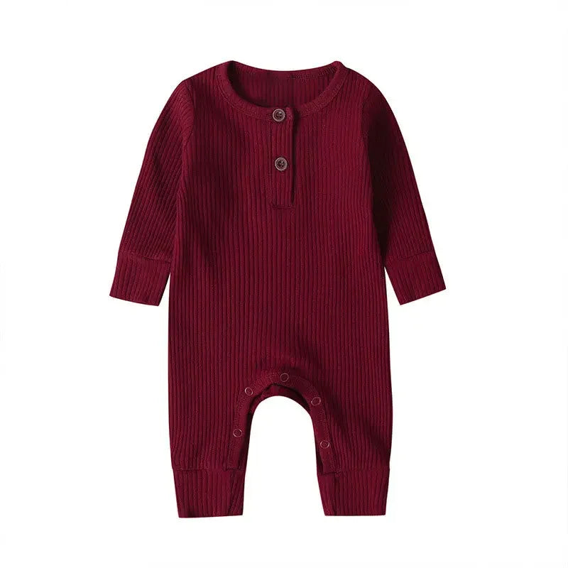 Comfortable unisex baby jumpsuit in cotton, long sleeves ideal for autumn and indoor play.