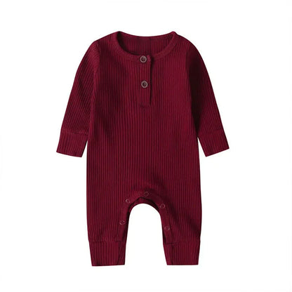 Comfortable unisex baby jumpsuit in cotton, long sleeves ideal for autumn and indoor play.
