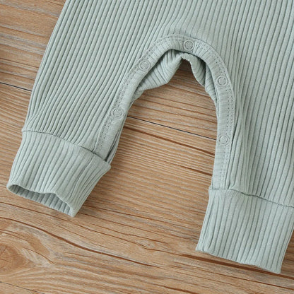 Adorable autumn baby romper, long sleeve and made from soft cotton, a unisex wardrobe staple.