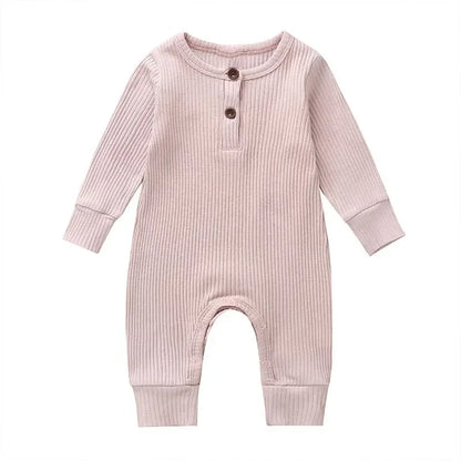 Newborn autumn outfit: unisex cotton romper with long sleeves, easy snap closures for diaper changes.