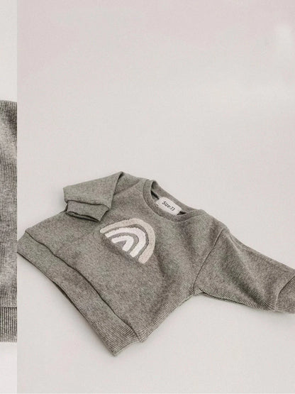 Folded unisex baby cotton ribbed clothing set, showcasing the compact and soft design, ready for travel