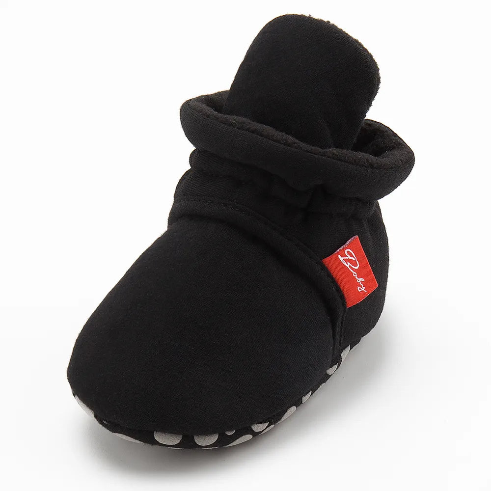 Close-up of the elastic ankle band on a unisex baby first walker sock shoe.