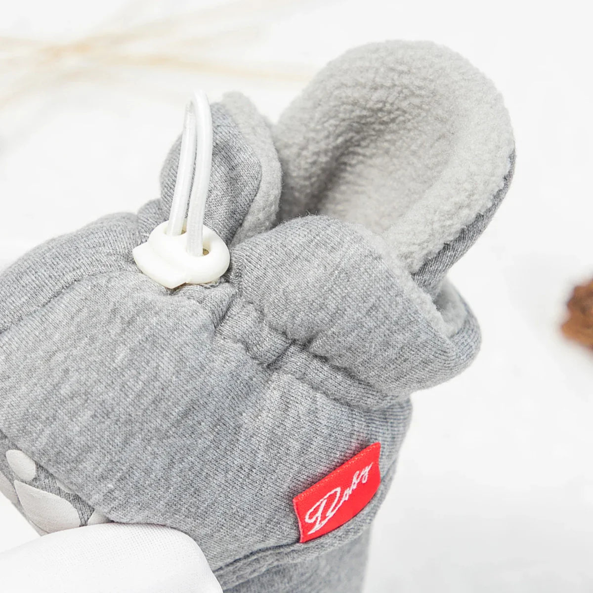 Newborn wearing blue soft sole first walker sock shoes, crawling on a playmat.