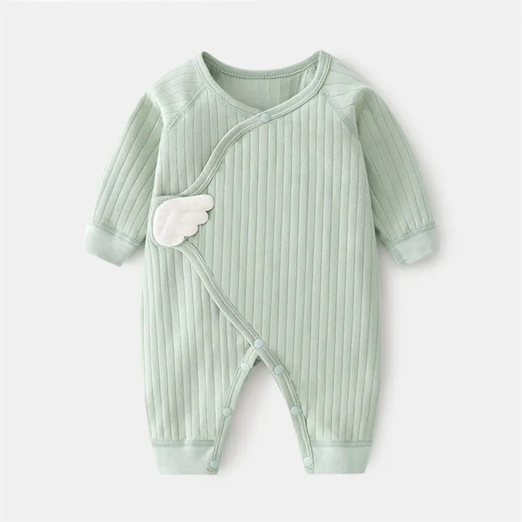 Stacked cotton baby rompers in various solid colors, essential newborn outfit collection