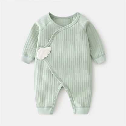 Stacked cotton baby rompers in various solid colors, essential newborn outfit collection