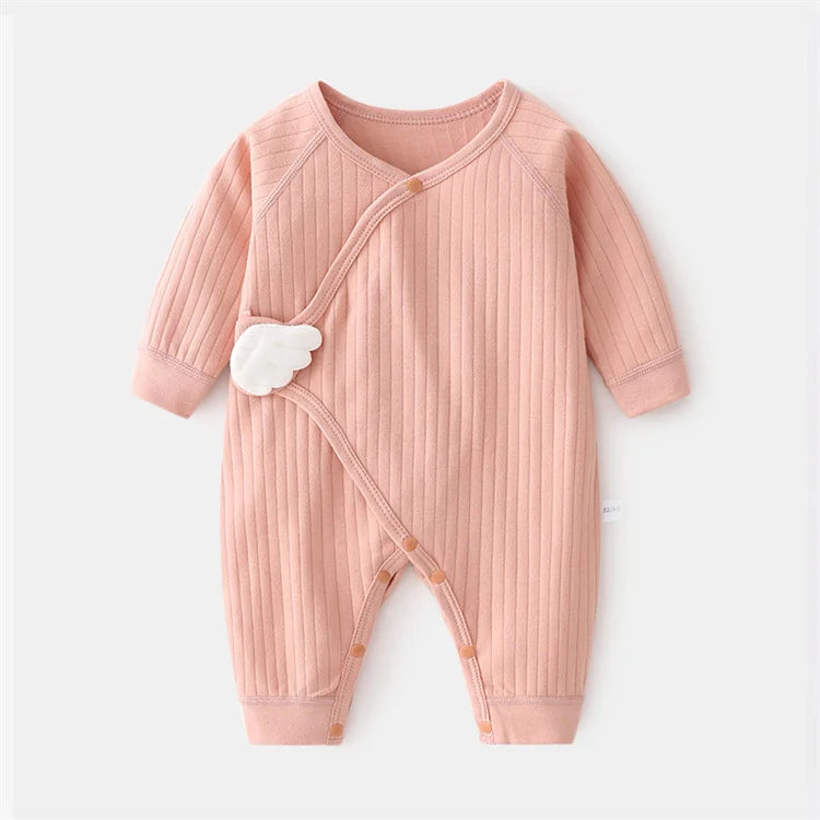 Unisex infant jumpsuit paired with small baby shoes, completing a cute baby fashion look