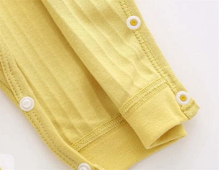 Collection of solid color infant rompers, offering versatile choices for unisex baby fashion