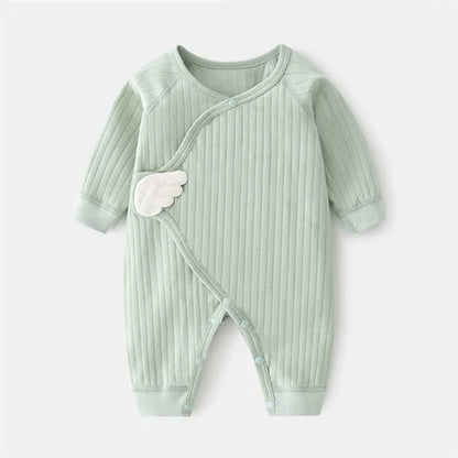 Cotton baby clothes on a hanger, ready for a newborn or infant's wardrobe