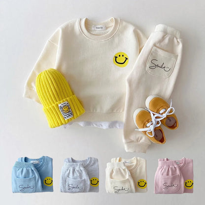 Unisex baby cotton tracksuit set in yellow with smiley face design, perfect for activewear, front view.