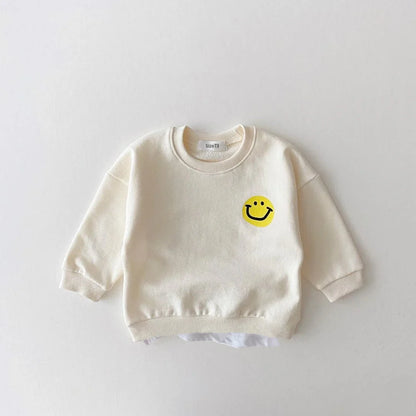 Unisex baby jogger set in vibrant yellow cotton, adorned with cheerful smiley faces, for infant play.