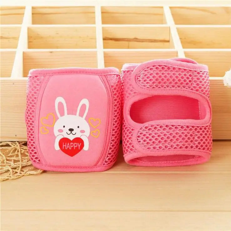 Baby crawling on hardwood floor with grey knee pads for added protection