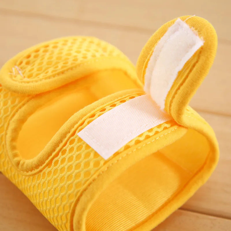 Toddler wearing grey crawling knee protectors, perfect for infant care and play