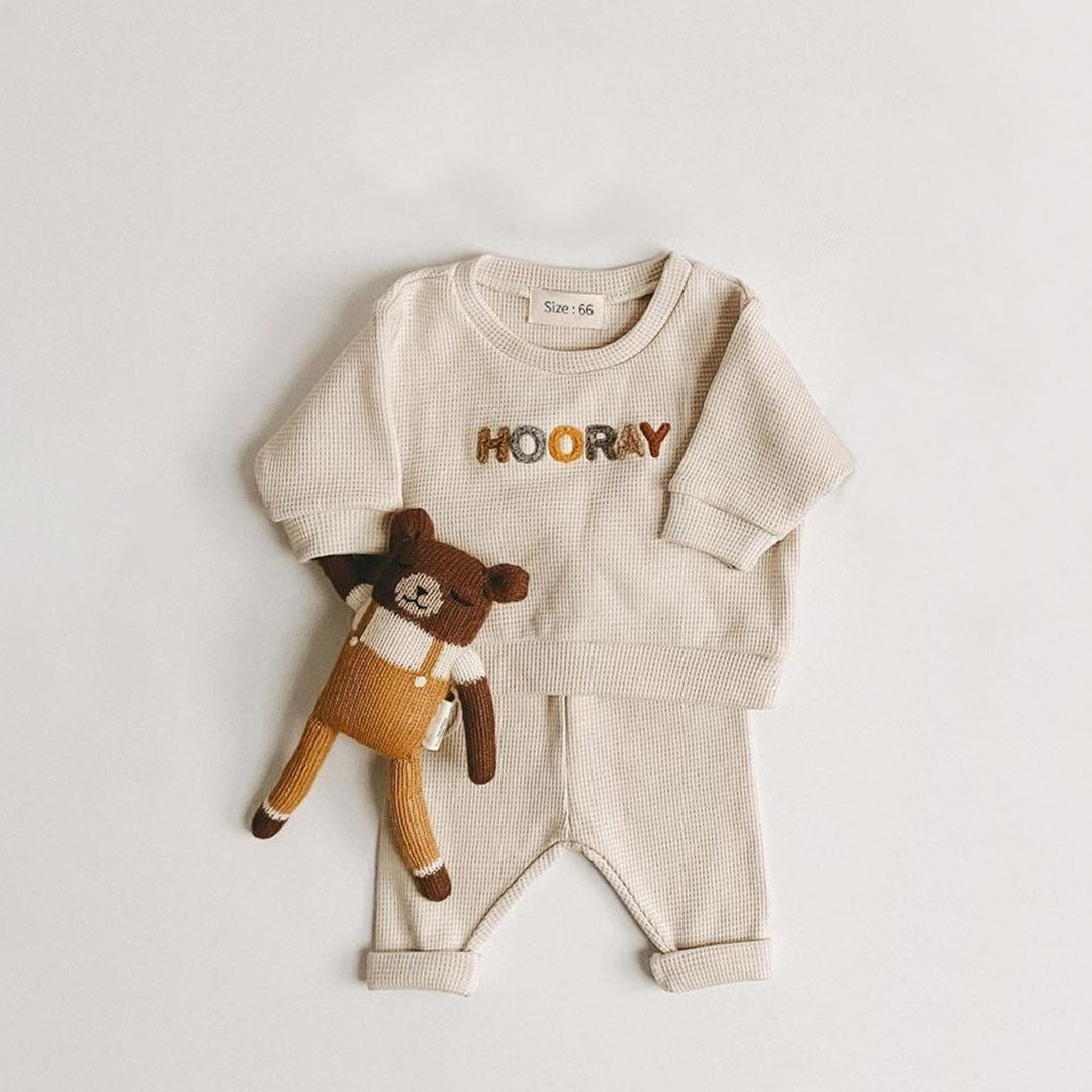 Stylish baby clothing set with a crew-neck top and leggings, ideal for infant casual wear.