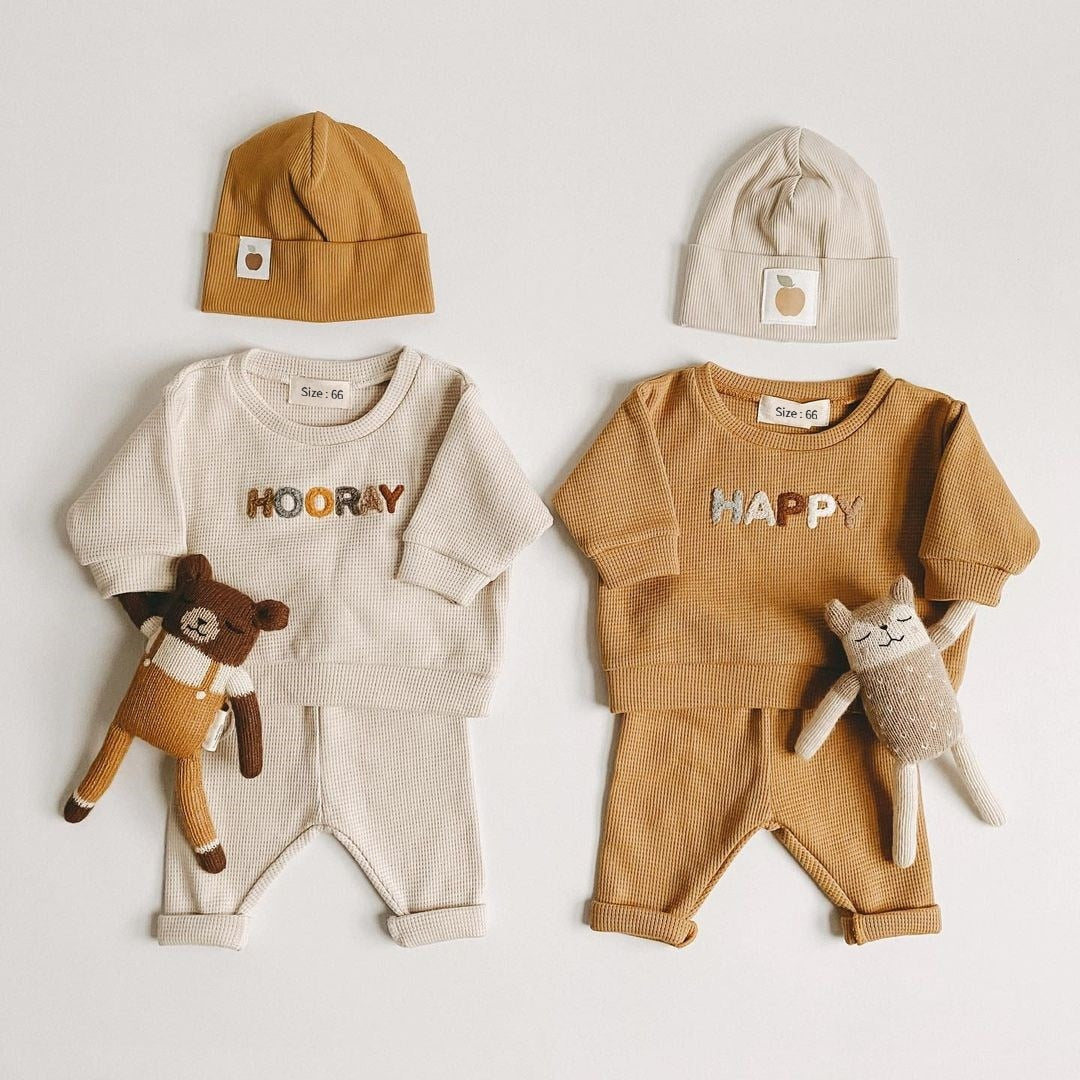Cute infant two-piece outfit for baby boys and girls, perfect for cool weather.