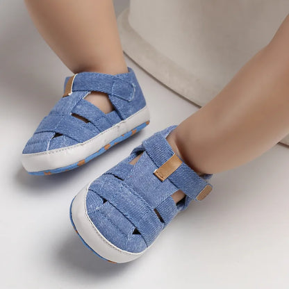 Close-up of a baby canvas first walker shoe, showing hook & loop closure and soft sole.