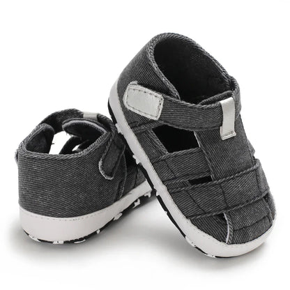 Baby in stylish canvas first walker shoes, anti-slip bottom, ideal for early walking.