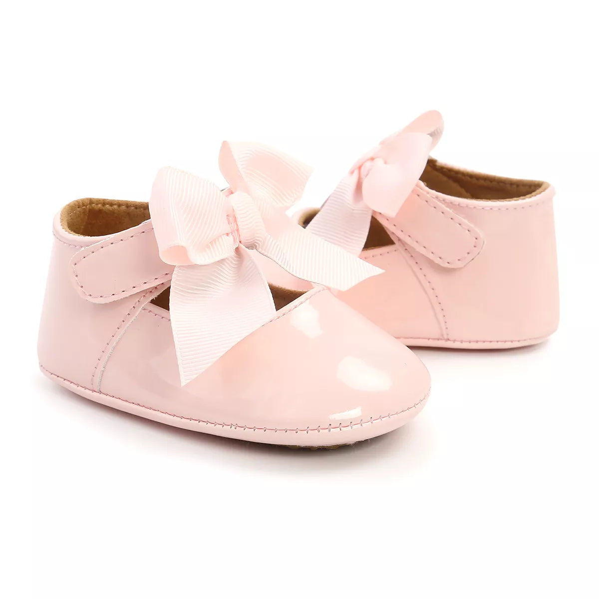 Close-up of the anti-slip sole on white unisex baby first walker shoes, ensuring stability for infants