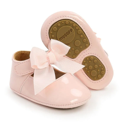 Close-up of white unisex baby first walker shoes with anti-slip soft sole and comfortable design