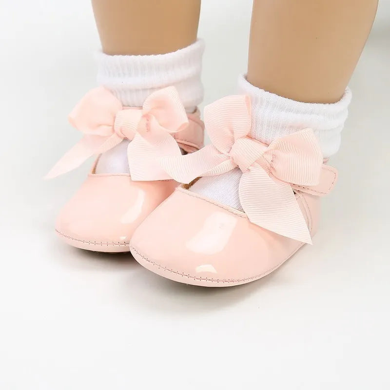 Pair of white unisex baby first walker shoes with anti-slip bottom, ideal for new walkers, soft PU
