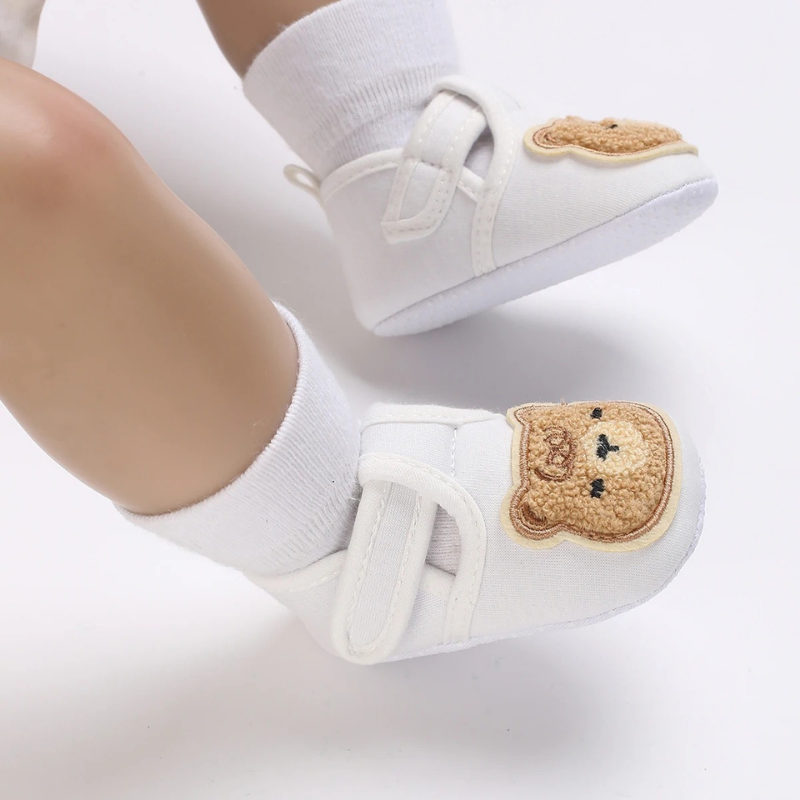 Close-up of unisex baby first steps shoes, cotton anti-slip sole for safe walking