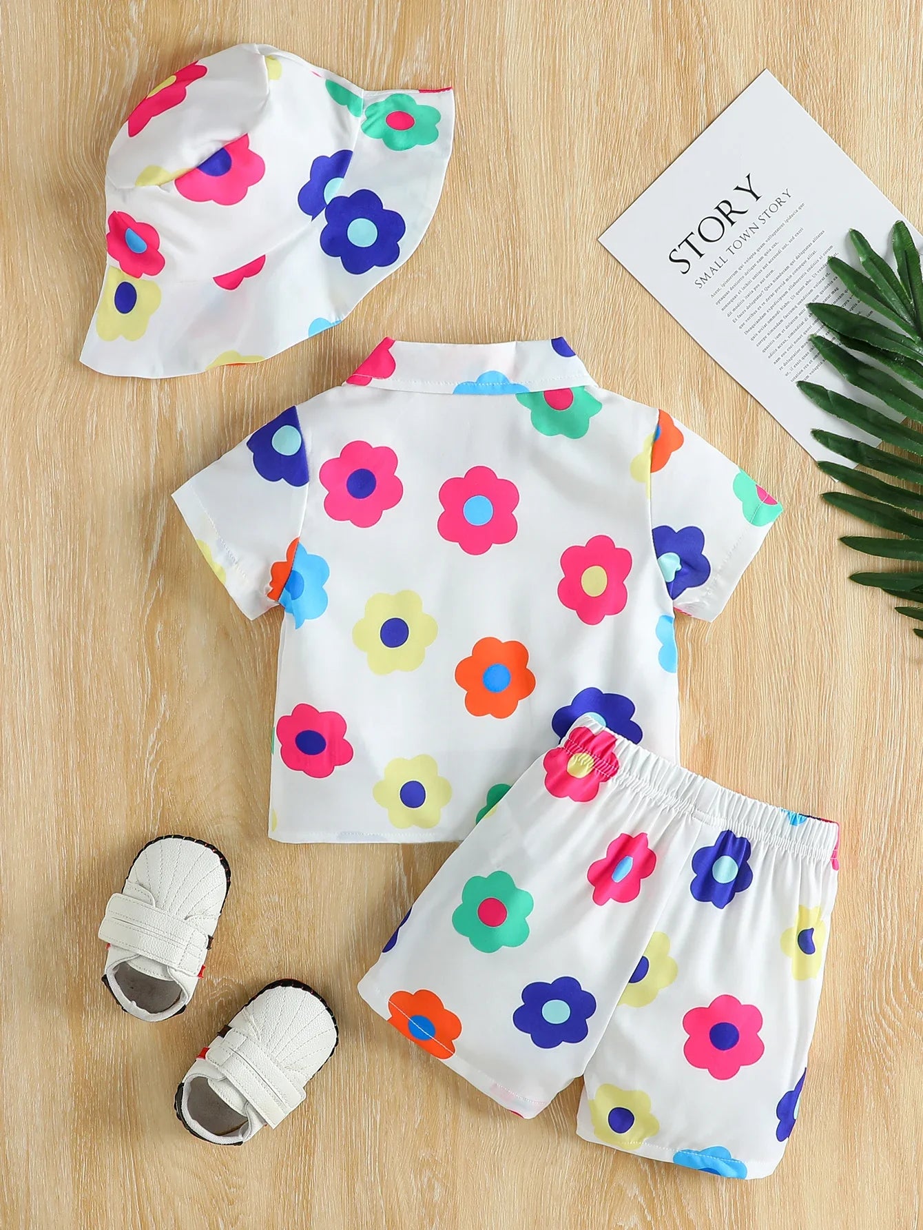 Close-up of unisex baby short-sleeve romper with vibrant floral print for summer fashion